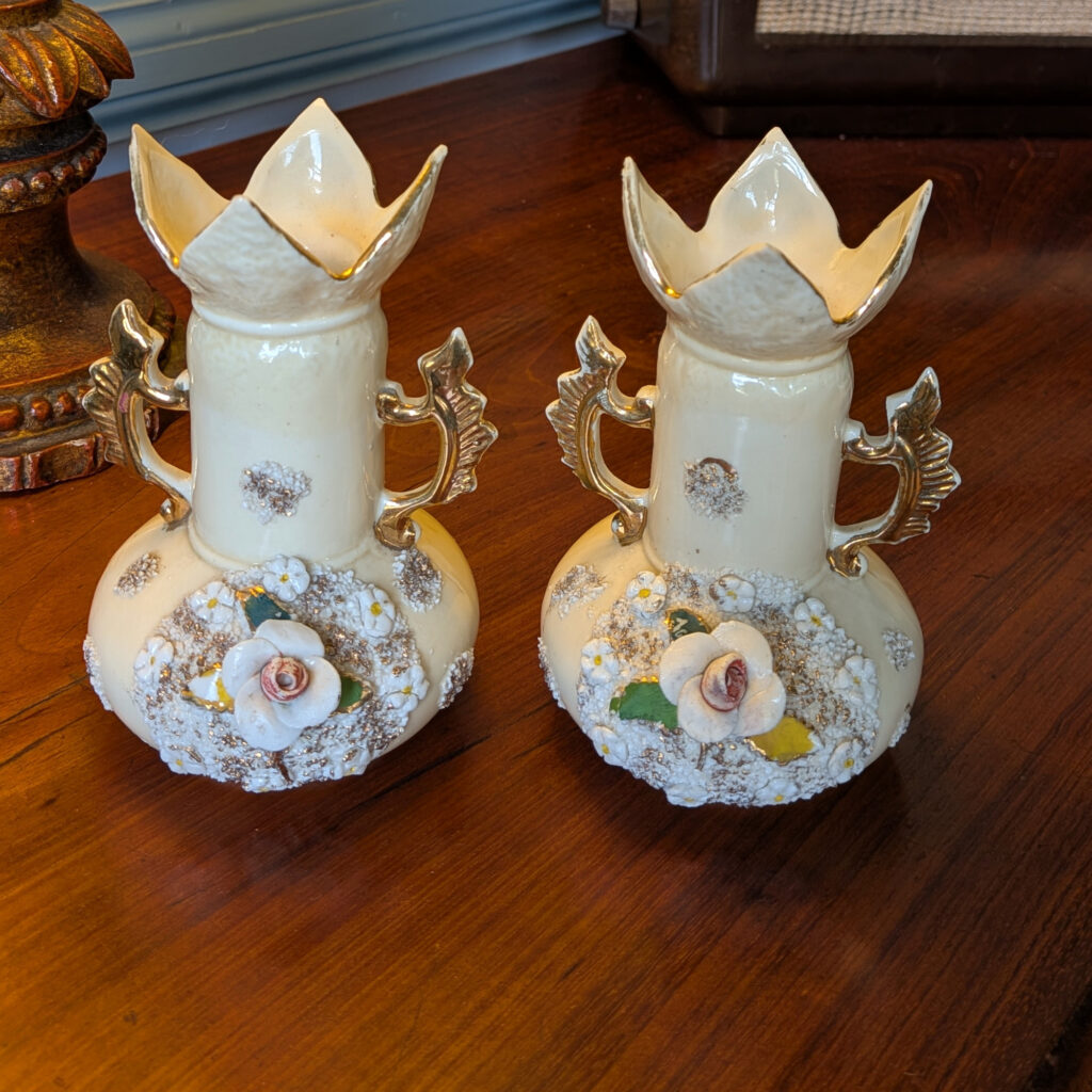 PC79 pair of cream ceramic vases with applied flowers, gilt handles and petal-shaped rims, front view