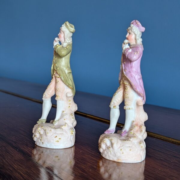 Left side view of the pair of courtier figurines on decorated bases
