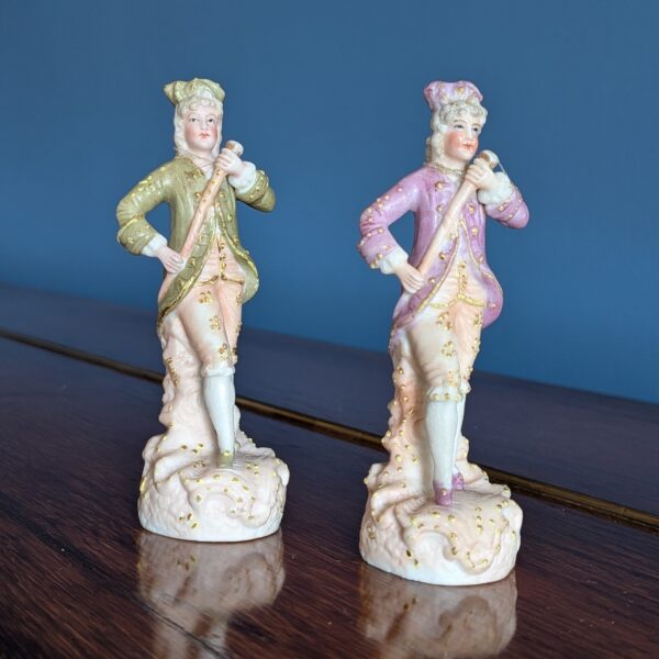 Three-quarter view of the courtier figurines and their decorated bases