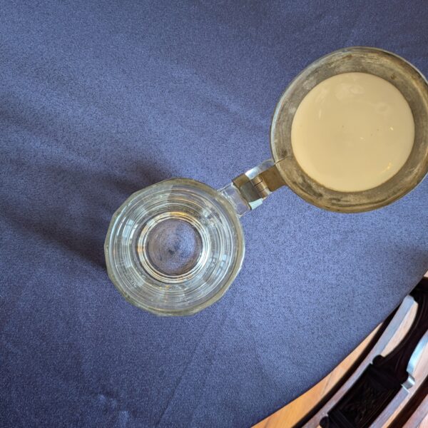 View from above of the glass tankard interior and the underside of its open lid.