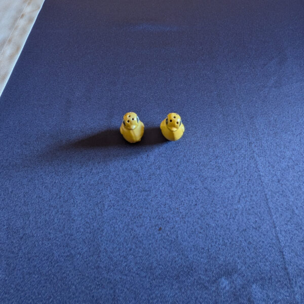 Pair of miniature yellow chick salt and pepper shakers, front view.