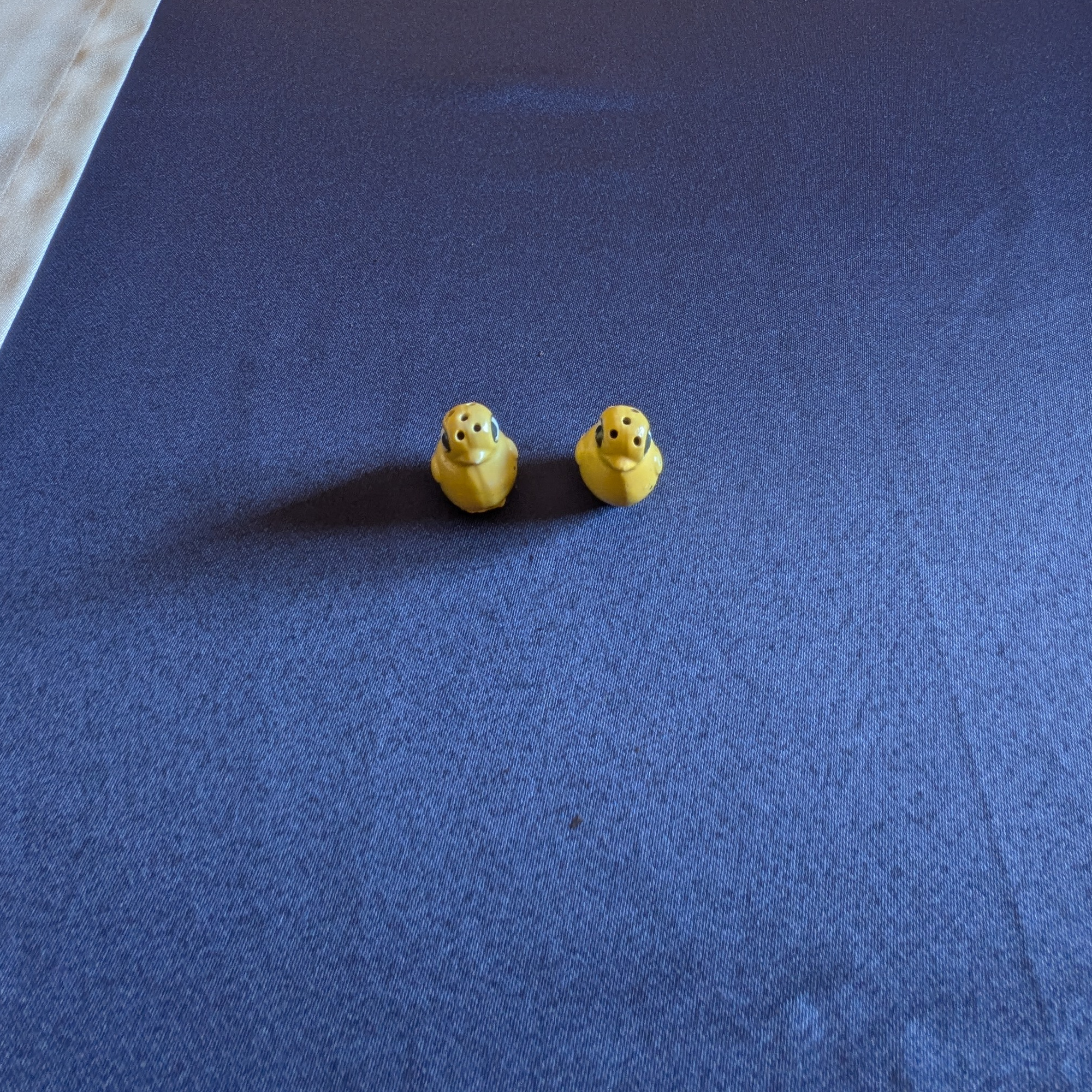 Pair of miniature yellow chick salt and pepper shakers, front view.
