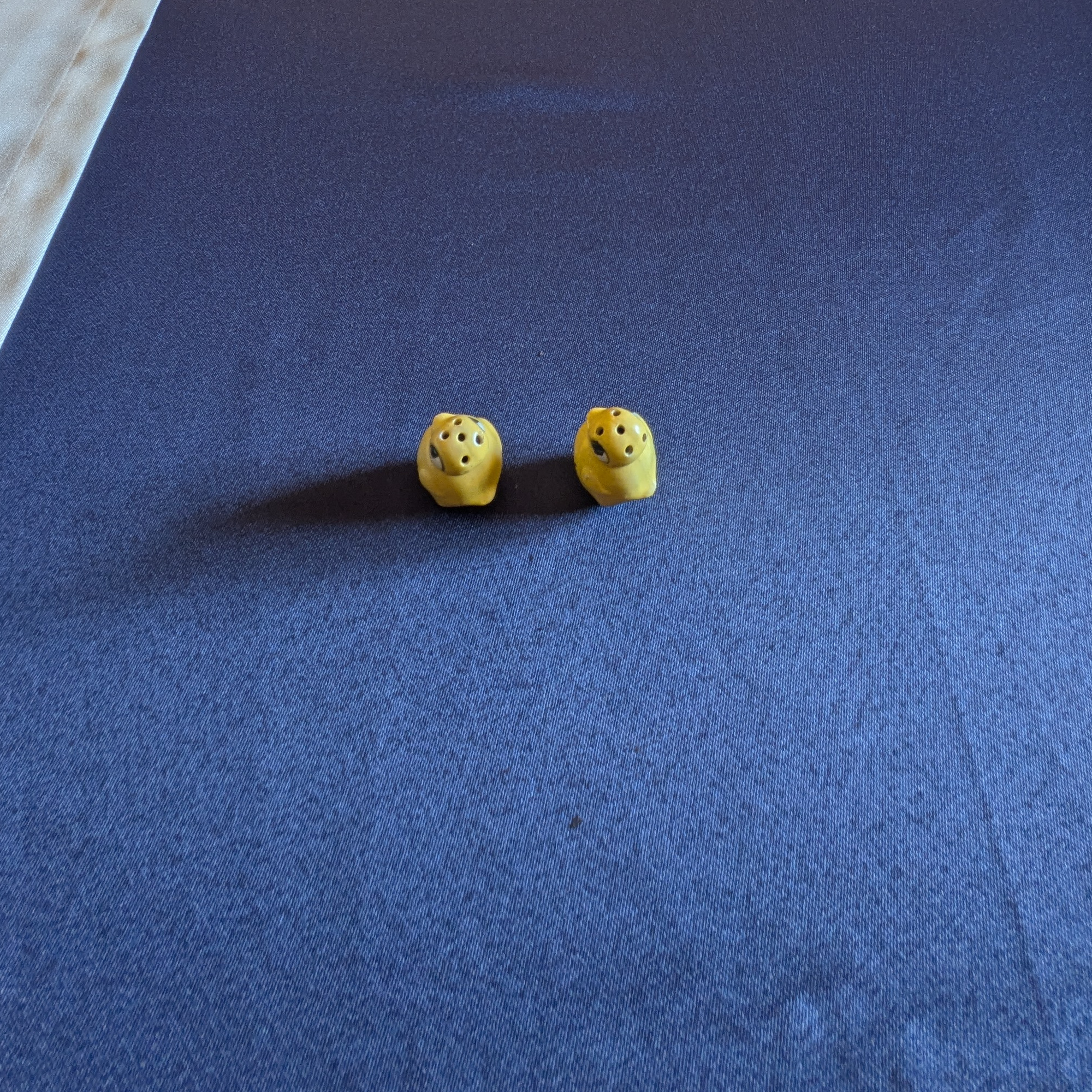 View from above showing the dispensing holes on the two yellow chick shakers.