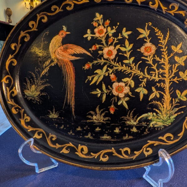 Detail of the long-tailed bird, flowers and gold scrolling border.