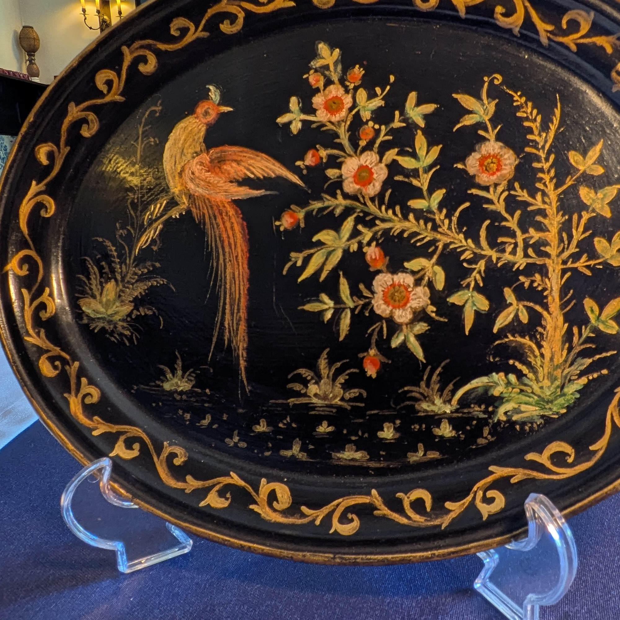Detail of the long-tailed bird, flowers and gold scrolling border.
